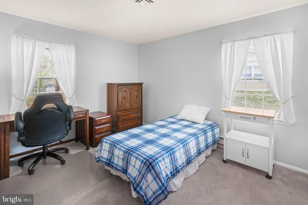 a bedroom with a bed a desk and chair