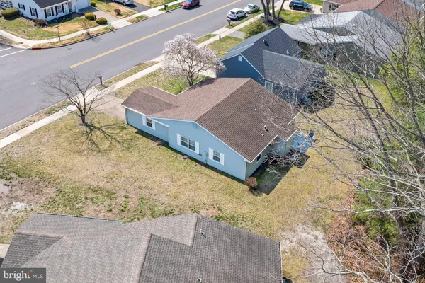an aerial view of a house with a yard and sitting space