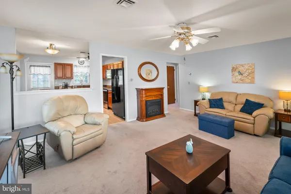 a living room with furniture a table and a chandelier