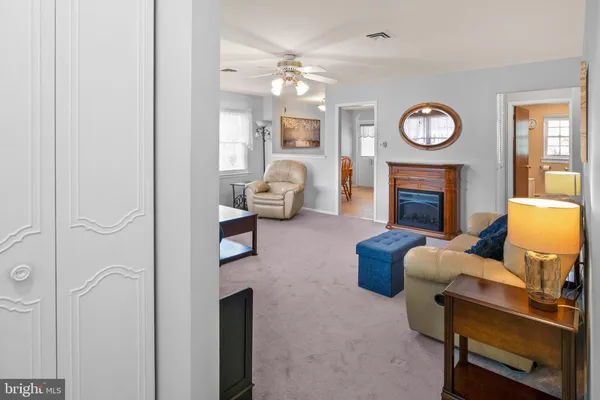a living room with furniture a clock and a fireplace