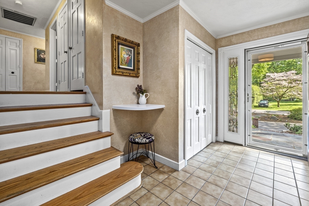 74 Brook Road Sharon, MA 02067 - Photo 16 of 32 a view of a room that has a bed and a window in it