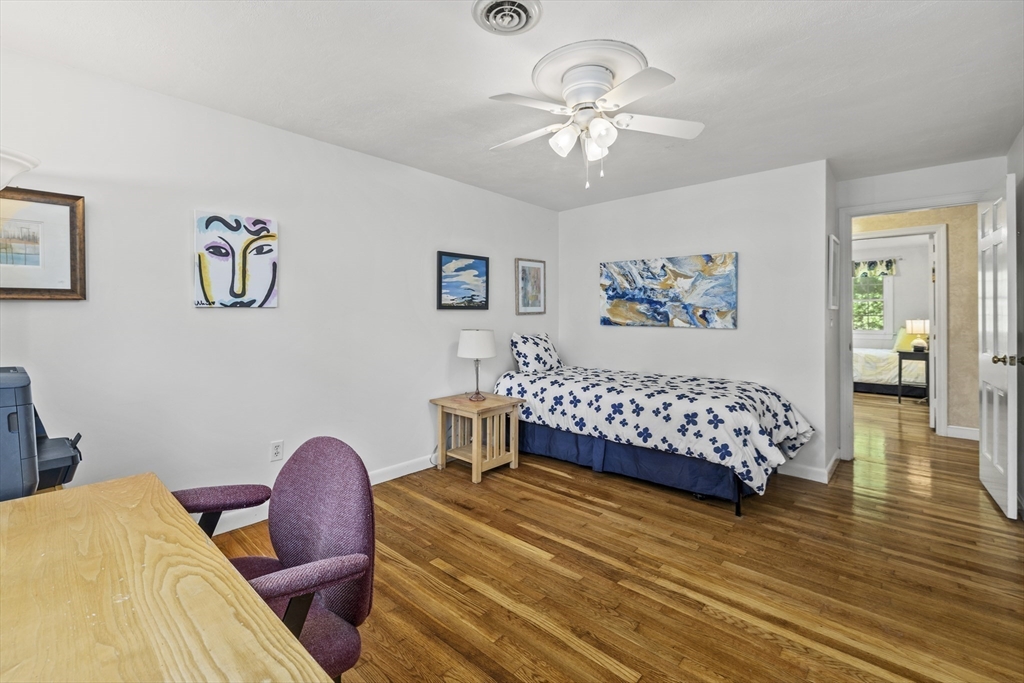 74 Brook Road Sharon, MA 02067 - Photo 18 of 32 a bedroom with a bed and wooden floor