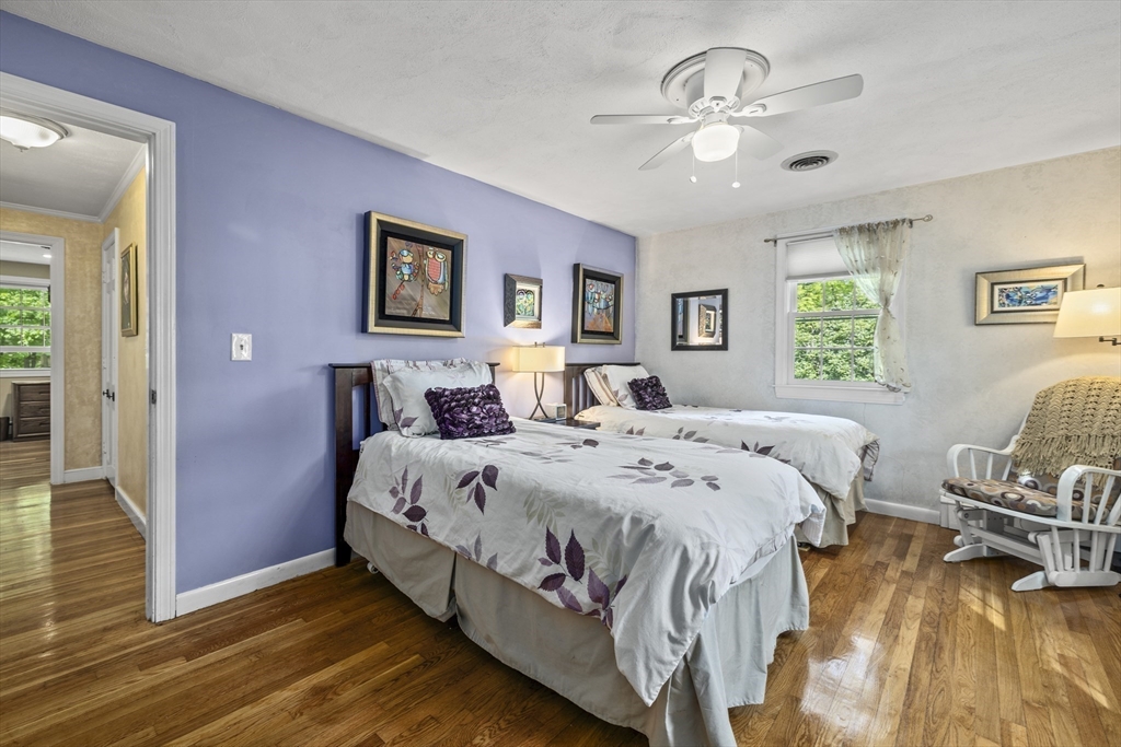 74 Brook Road Sharon, MA 02067 - Photo 20 of 32 a spacious bedroom with a bed and a chandelier