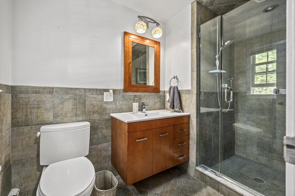 74 Brook Road Sharon, MA 02067 - Photo 24 of 32 a bathroom with a toilet sink and mirror