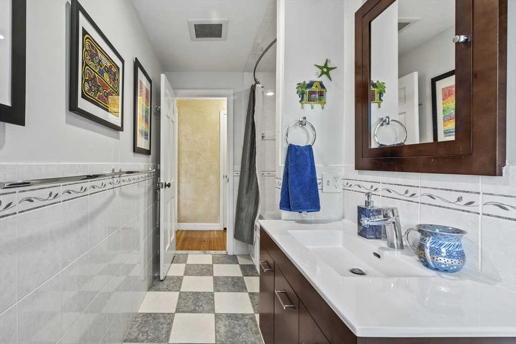 74 Brook Road Sharon, MA 02067 - Photo 26 of 32 a bathroom with a sink double vanity and a mirror