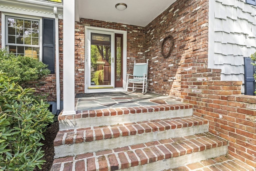 74 Brook Road Sharon, MA 02067 - Photo 3 of 32 a view of a brick house with large windows