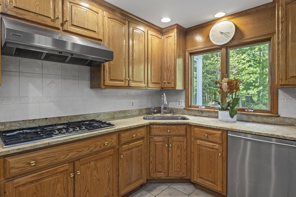 74 Brook Road Sharon, MA 02067 - Photo 9 of 32 a kitchen with stainless steel appliances granite countertop a sink a window and cabinets