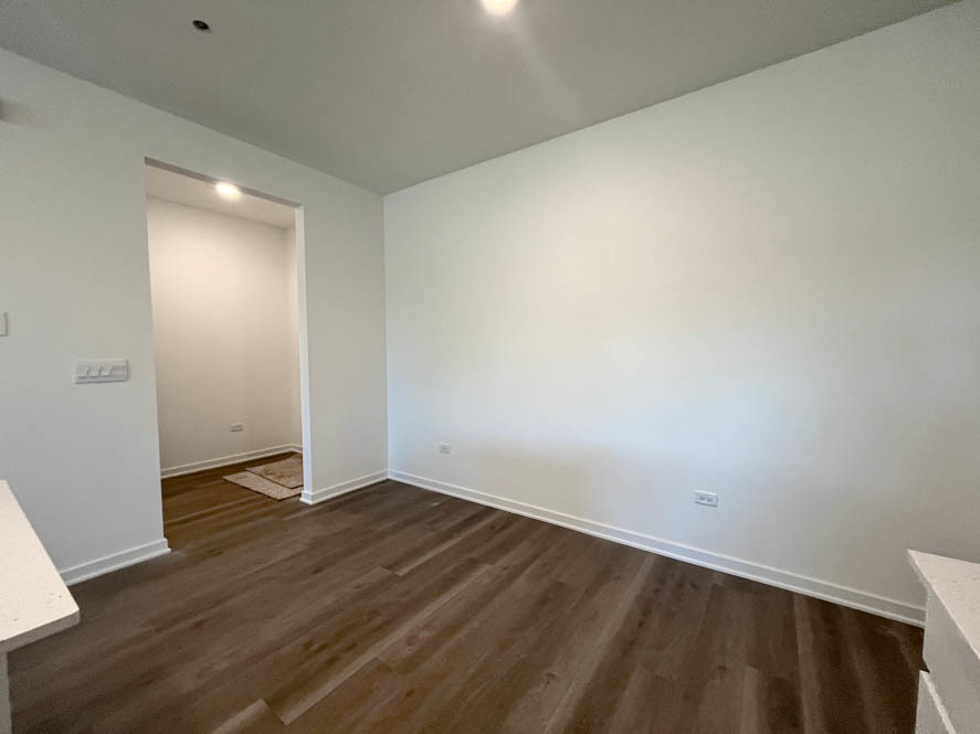 2108 Bodega Drive Oswego, IL 60543 - Photo 12 of 36 an empty room with wooden floor and windows