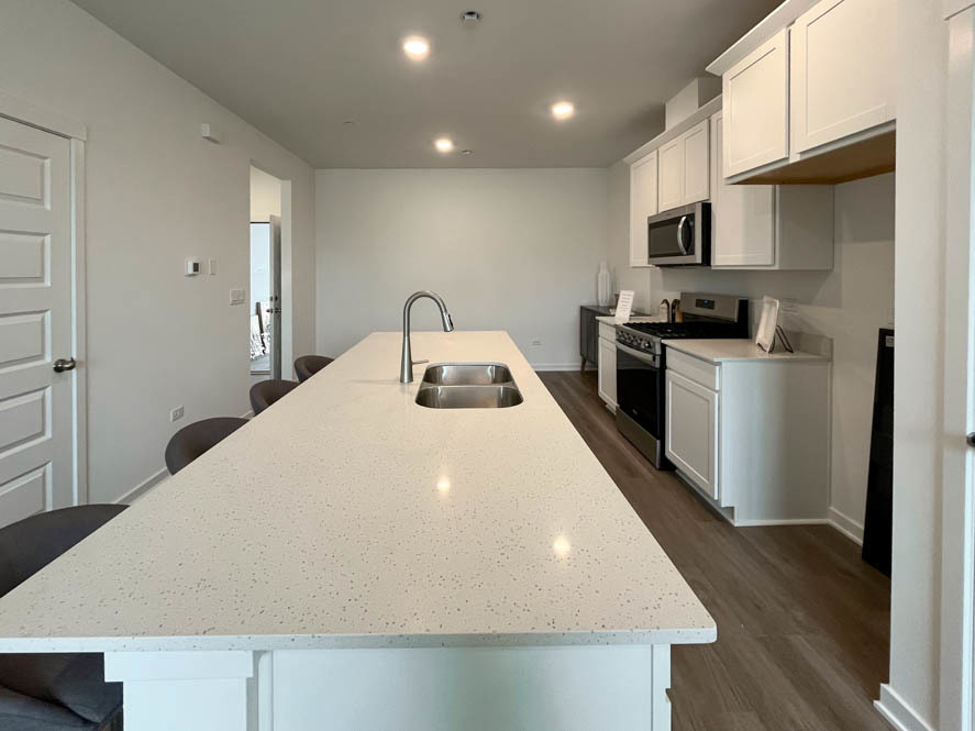 2108 Bodega Drive Oswego, IL 60543 - Photo 20 of 36 a kitchen with a sink a stove and cabinets