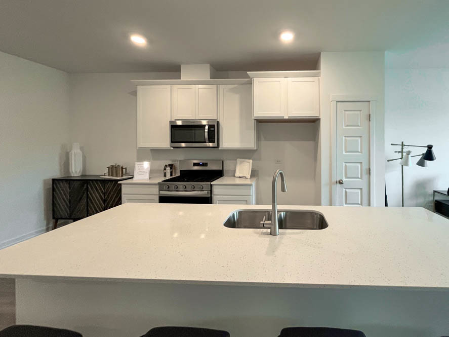 2108 Bodega Drive Oswego, IL 60543 - Photo 21 of 36 a kitchen with kitchen island a sink stainless steel appliances and cabinets