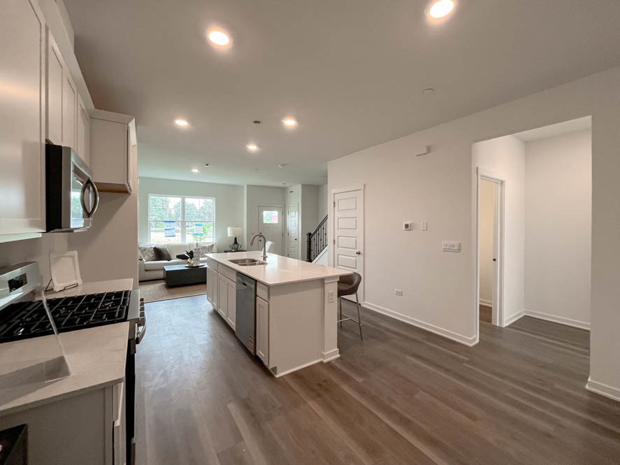 2108 Bodega Drive Oswego, IL 60543 - Photo 23 of 36 a kitchen with a sink cabinets and wooden floor