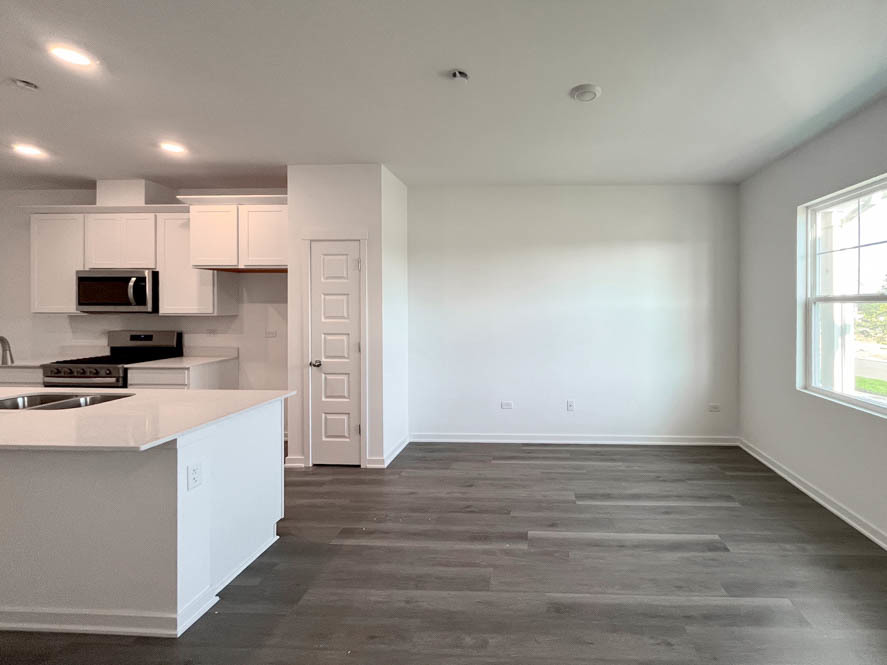 2108 Bodega Drive Oswego, IL 60543 - Photo 7 of 36 a view of kitchen with wooden floor and electronic appliances