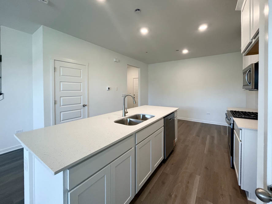 2108 Bodega Drive Oswego, IL 60543 - Photo 9 of 36 a kitchen that has a sink a stove and a refrigerator