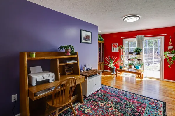 a living room with furniture a rug and a flat screen tv