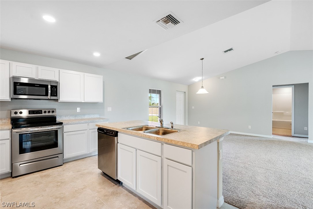 2819 37th Street Southwest Lehigh Acres, FL 33976 - Photo 5 of 14 a kitchen with a sink stove and microwave