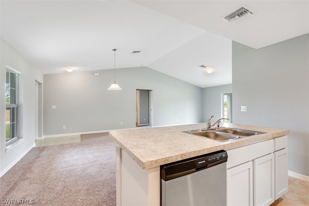 2819 37th Street Southwest Lehigh Acres, FL 33976 - Photo 6 of 14 a kitchen with a sink and a refrigerator