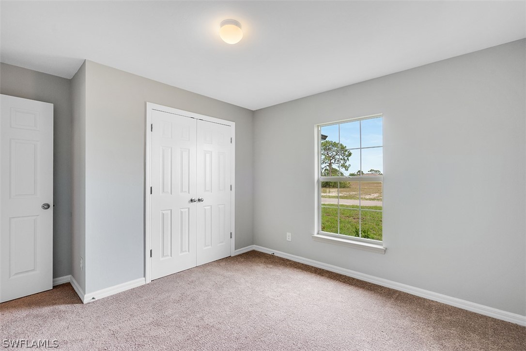 2819 37th Street Southwest Lehigh Acres, FL 33976 - Photo 8 of 14 an empty room with windows