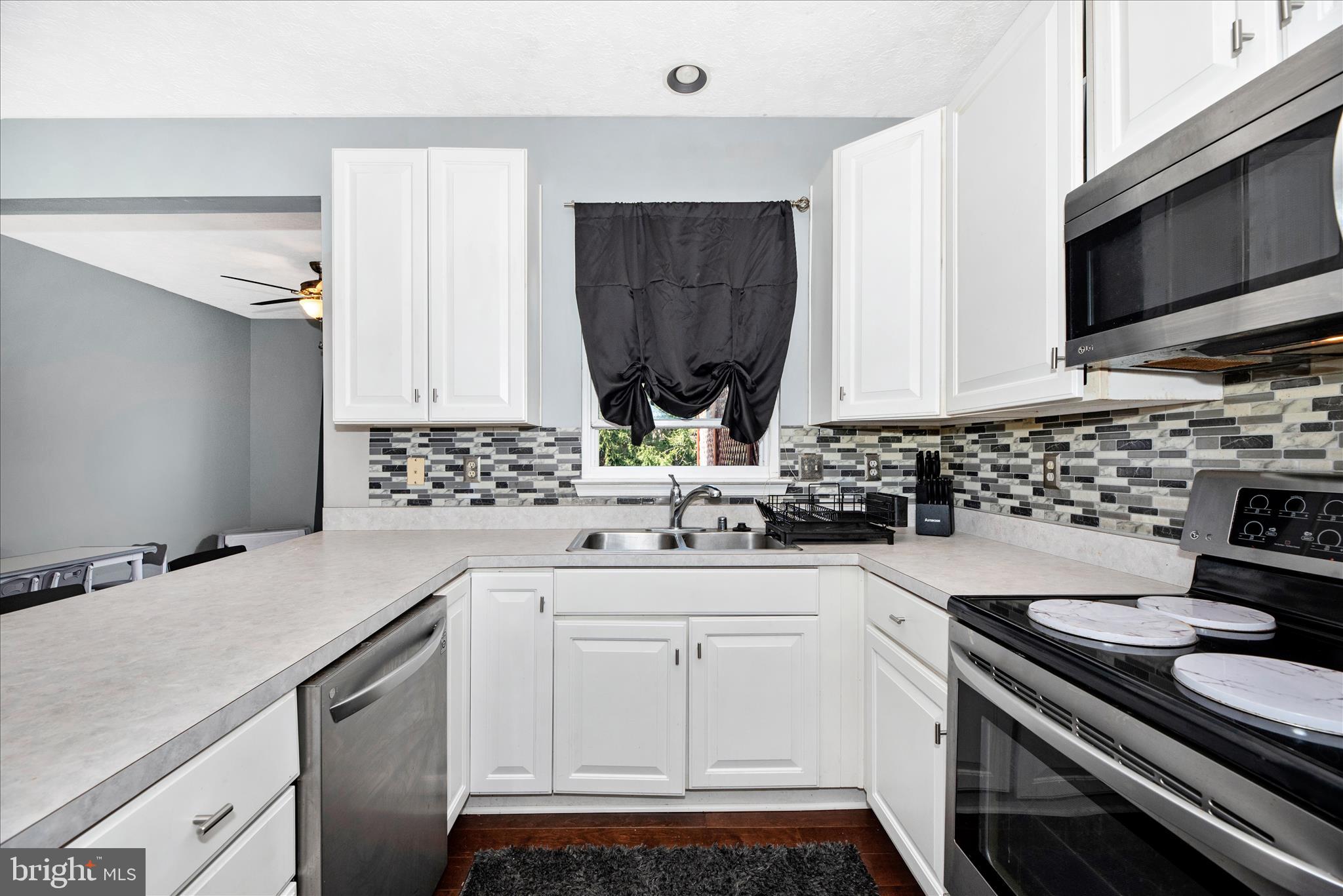 1422 Roman Ridge Way Bel Air, MD 21014 - Photo 15 of 57 a kitchen with a sink stove and microwave