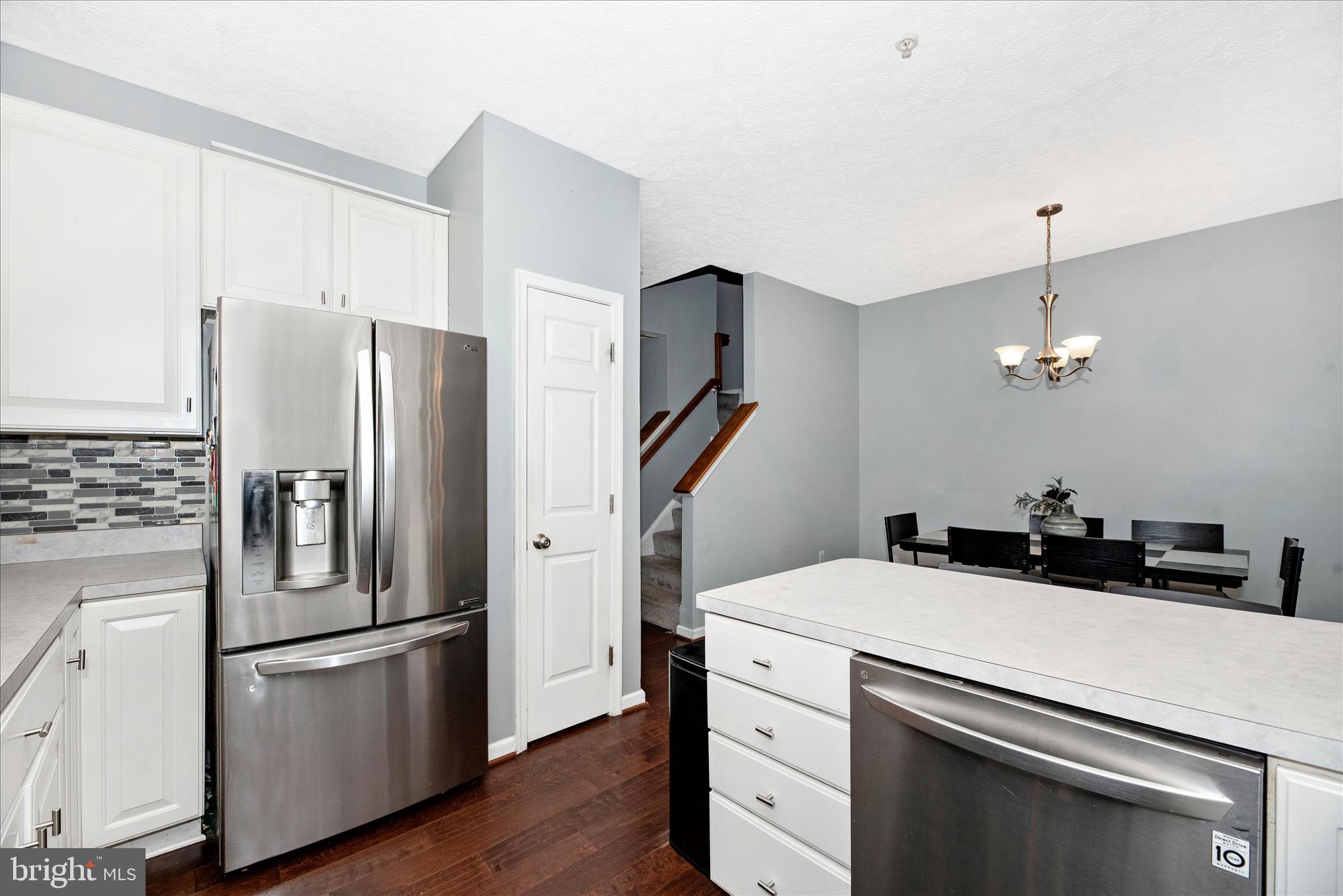 1422 Roman Ridge Way Bel Air, MD 21014 - Photo 17 of 57 a kitchen with stainless steel appliances a refrigerator sink and wooden floor