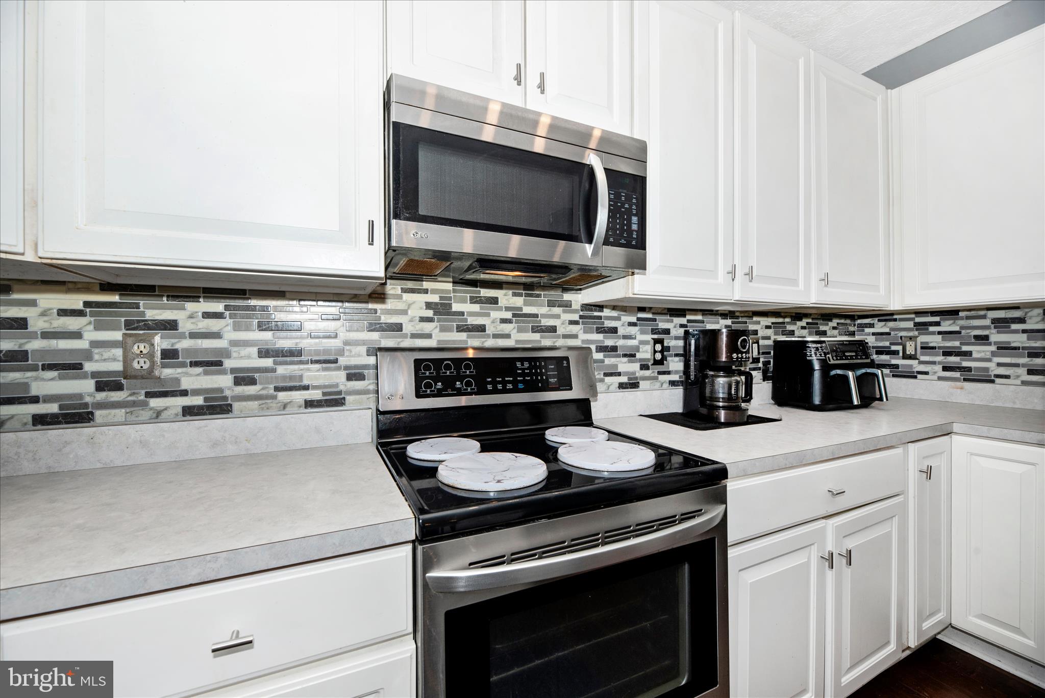 1422 Roman Ridge Way Bel Air, MD 21014 - Photo 18 of 57 a kitchen with a stove and a microwave