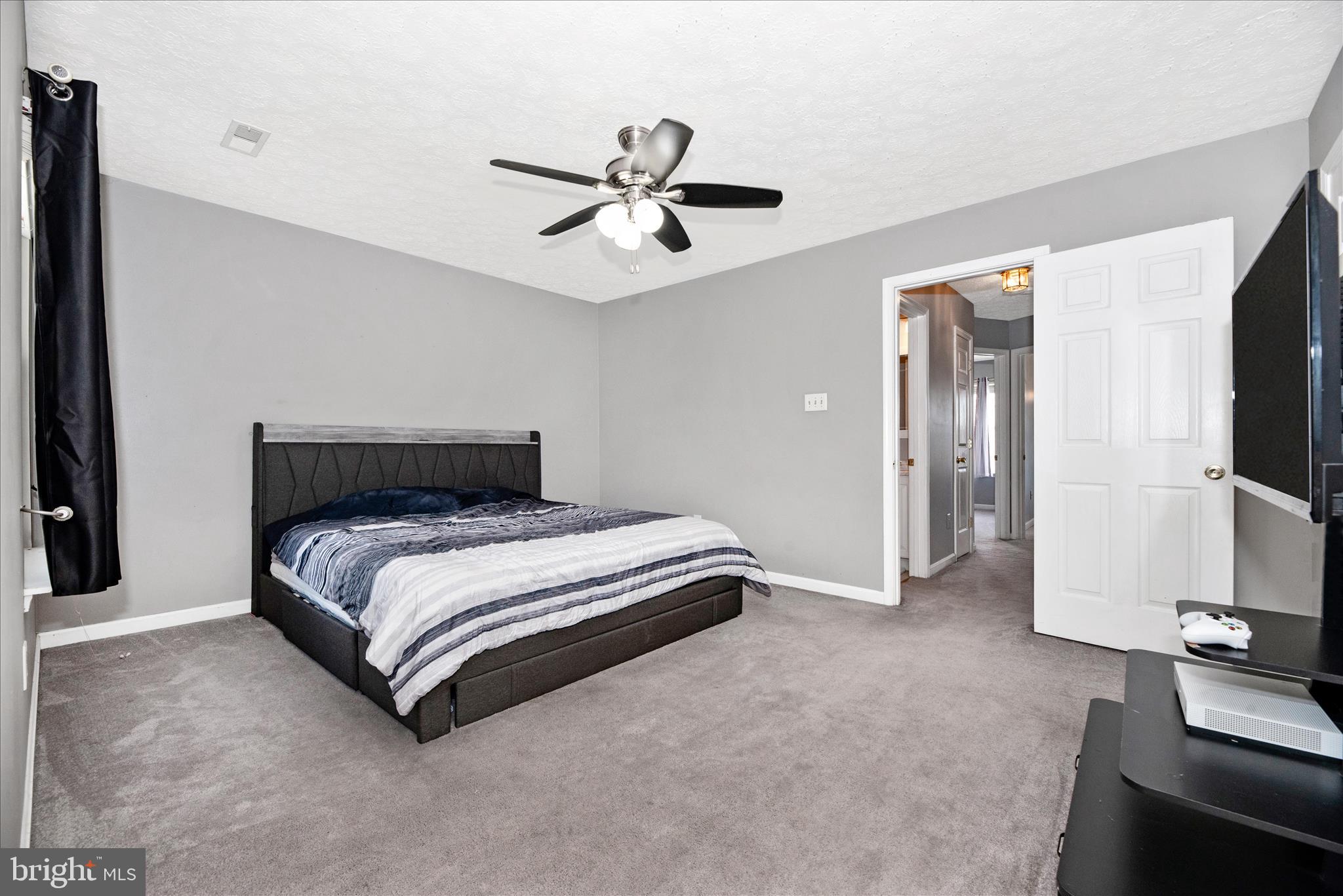 1422 Roman Ridge Way Bel Air, MD 21014 - Photo 27 of 57 a spacious bedroom with a bed and a flat screen tv
