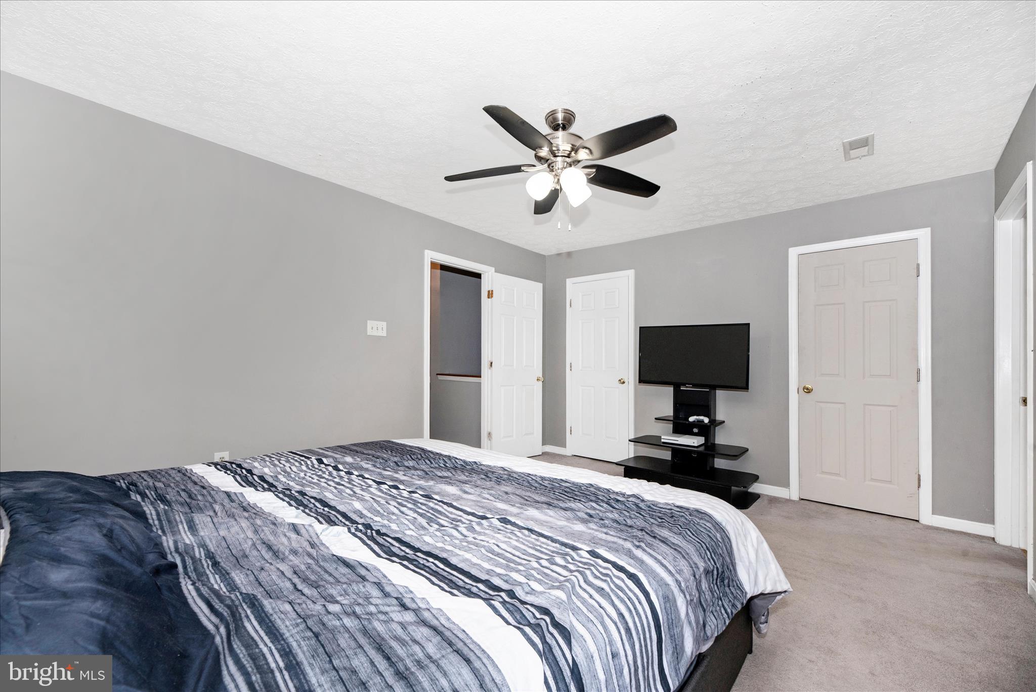 1422 Roman Ridge Way Bel Air, MD 21014 - Photo 28 of 57 a bedroom with a bed and a flat tv screen on wall