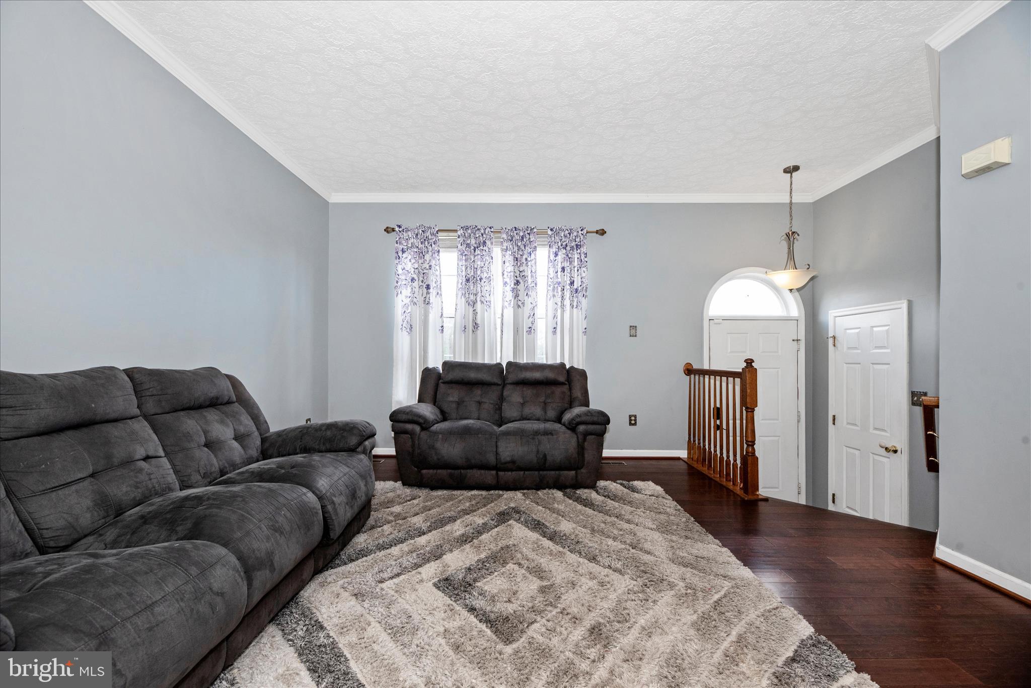 1422 Roman Ridge Way Bel Air, MD 21014 - Photo 5 of 57 a living room with furniture and a chandelier