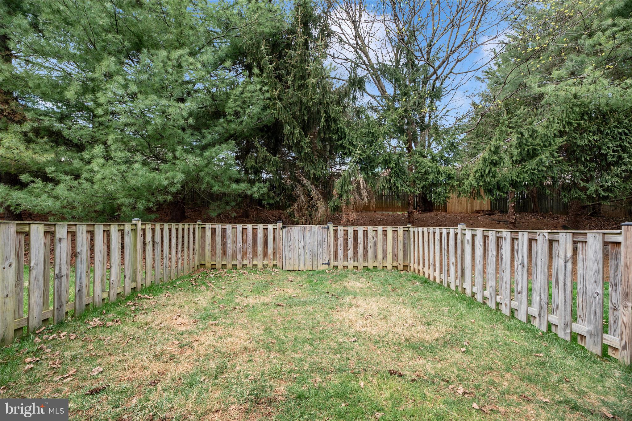 1422 Roman Ridge Way Bel Air, MD 21014 - Photo 51 of 57 a view of a yard with a large trees and wooden fence
