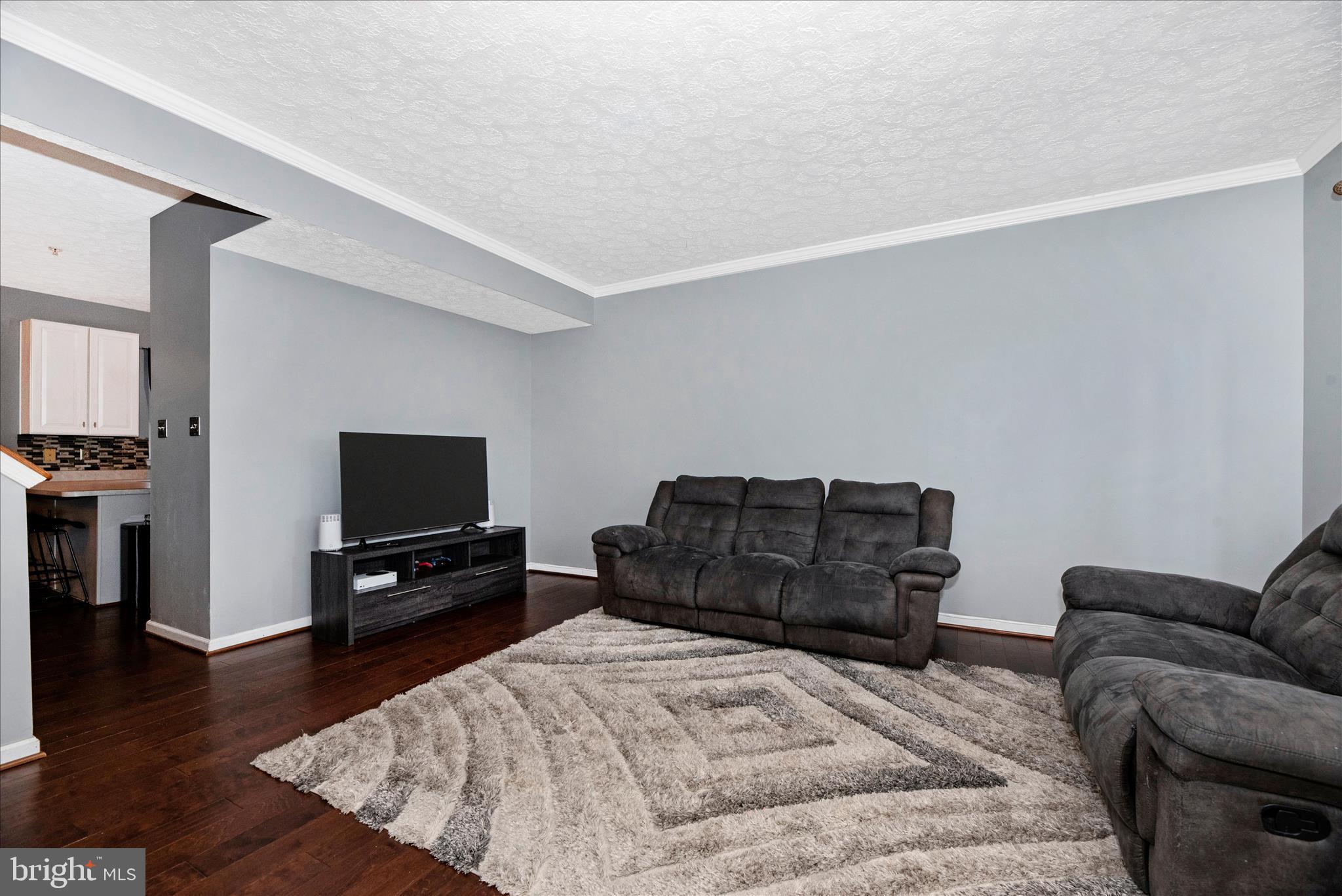 1422 Roman Ridge Way Bel Air, MD 21014 - Photo 9 of 57 a bedroom with a bed a television and wooden floor