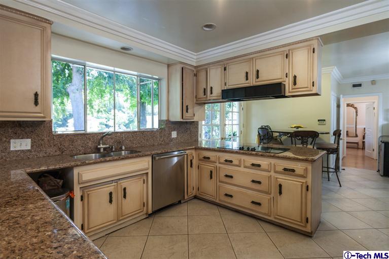 Undisclosed Address Pasadena, CA 91107 - Photo 7 of 16 a kitchen with stainless steel appliances granite countertop a stove a sink and a microwave