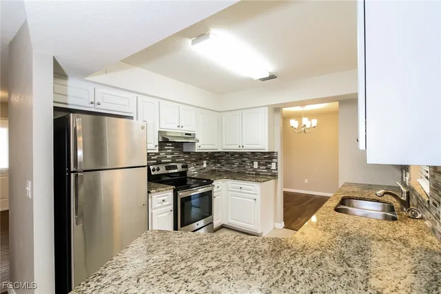 a kitchen with a refrigerator stove and sink