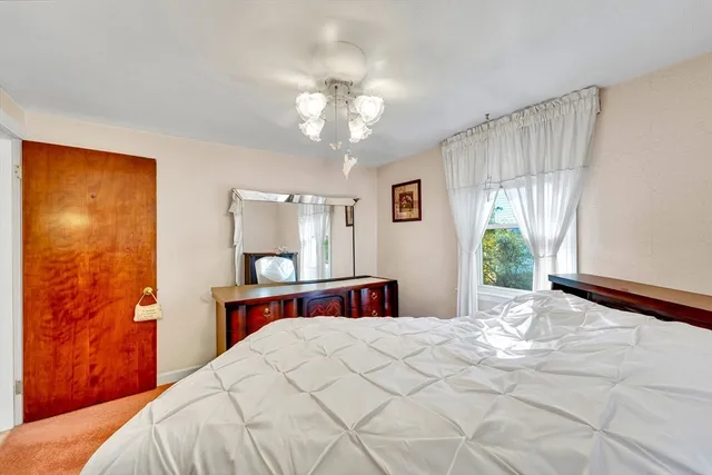 a bedroom with a large bed and a window