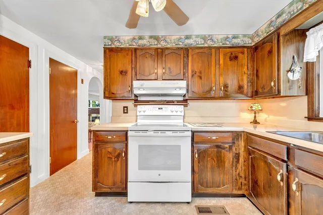 a kitchen with a sink stove and cabinets