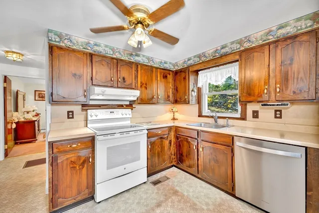 a kitchen with appliances cabinets and a sink