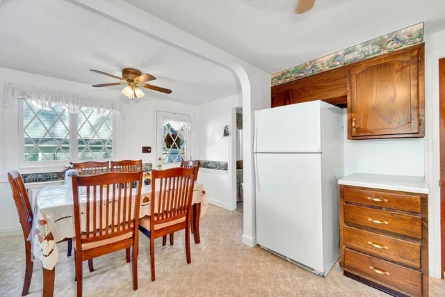 a dining room with furniture and a window