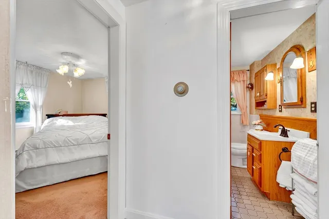 a en suite bathroom with a granite countertop sink and a mirror