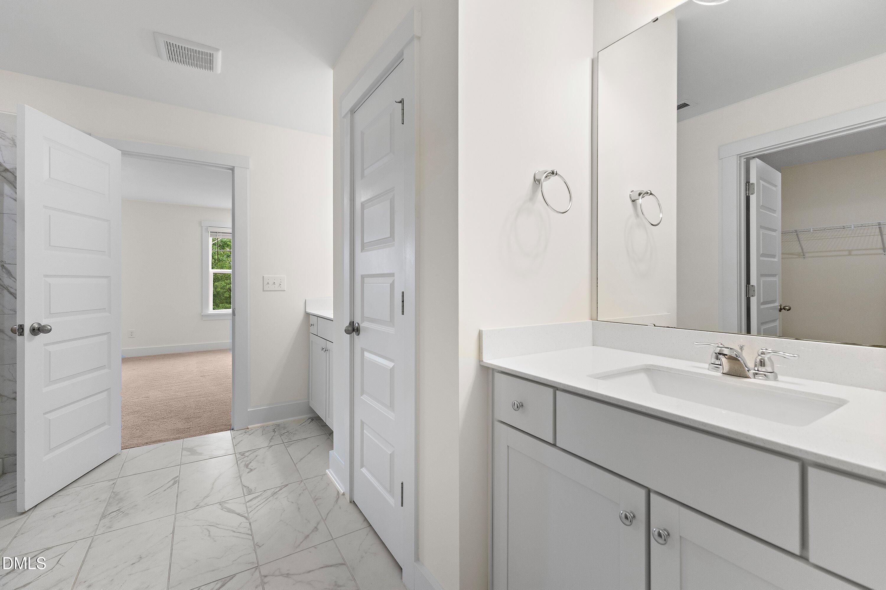156 Sears Ridge Lane Morrisville, NC 27560 - Photo 25 of 49 a spacious bathroom with a sink and a mirror