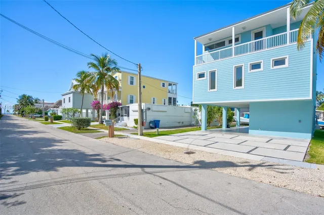 an aerial view of a house with an outdoor space and seating