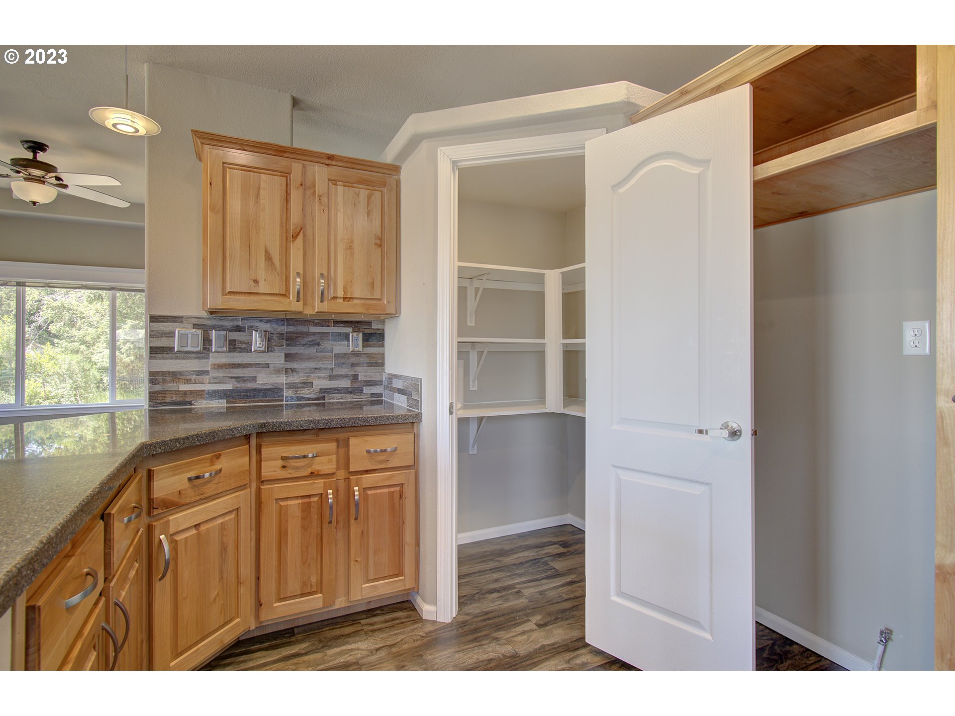 136 Stringtown Road Ilwaco, WA 98624 - Photo 17 of 47 a kitchen with granite countertop a refrigerator sink and cabinets