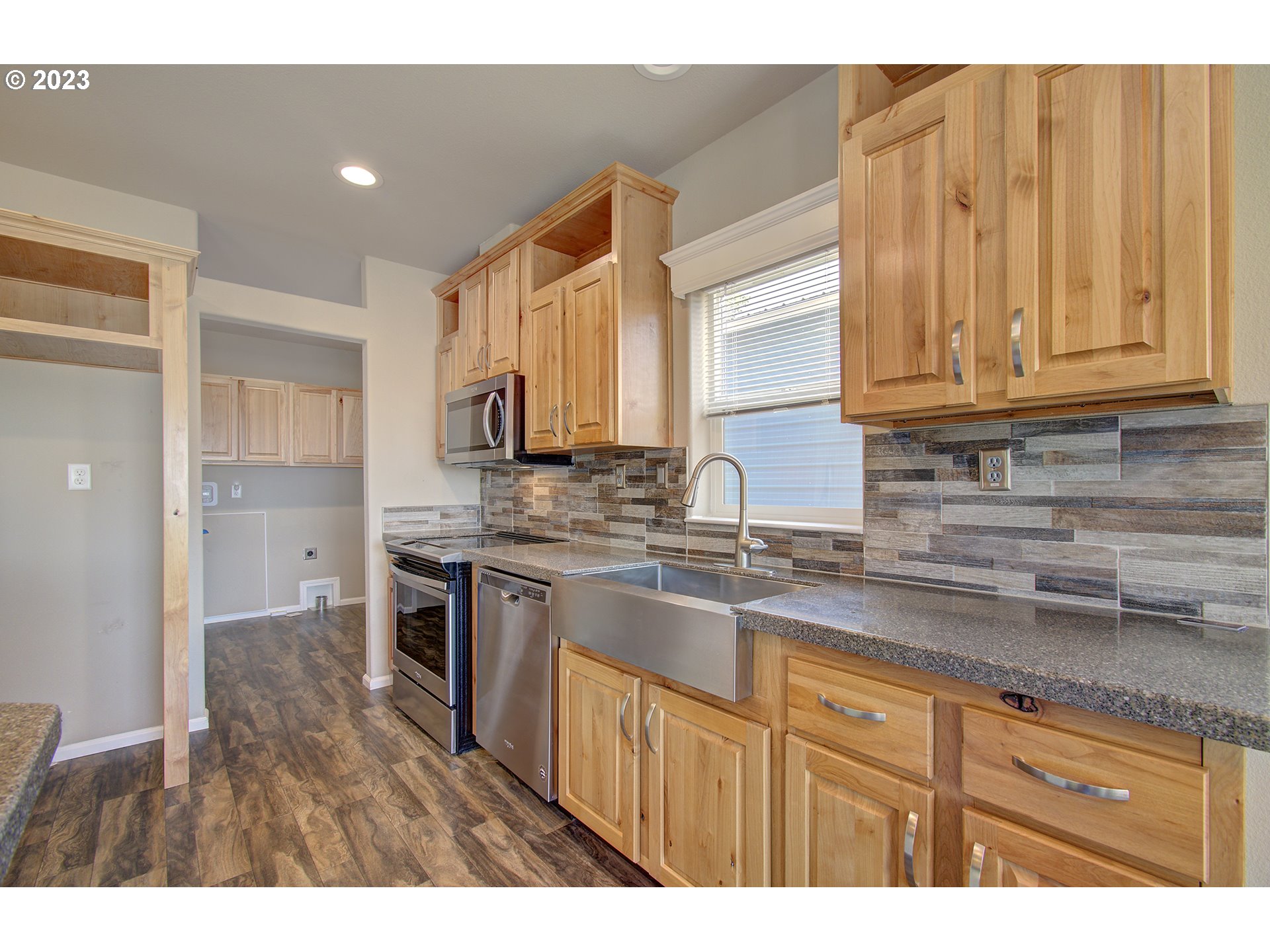136 Stringtown Road Ilwaco, WA 98624 - Photo 20 of 47 a kitchen with stainless steel appliances granite countertop a sink a stove and cabinets