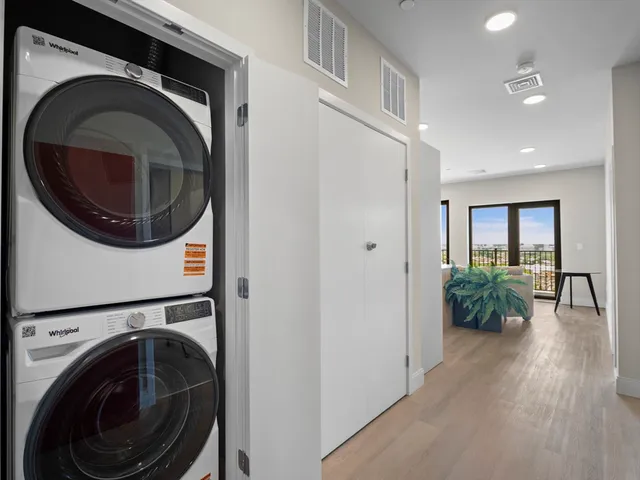 a view of a hallway with washer and dryer