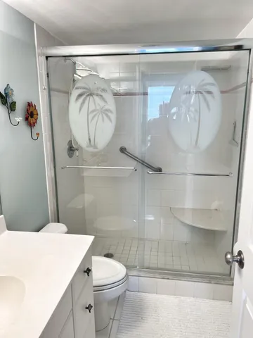 a view of a dining room with furniture large windows and wooden floor