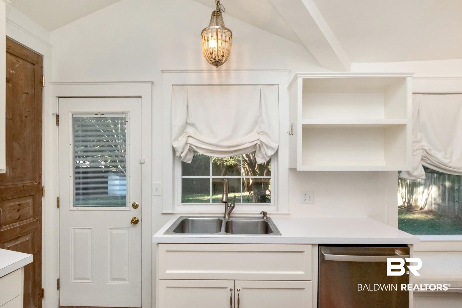 16 Princess Anne Road Mobile, AL 36608 - Photo 22 of 40 Kitchen featuring light countertops, dishwasher, white cabinets, and lofted ceiling
