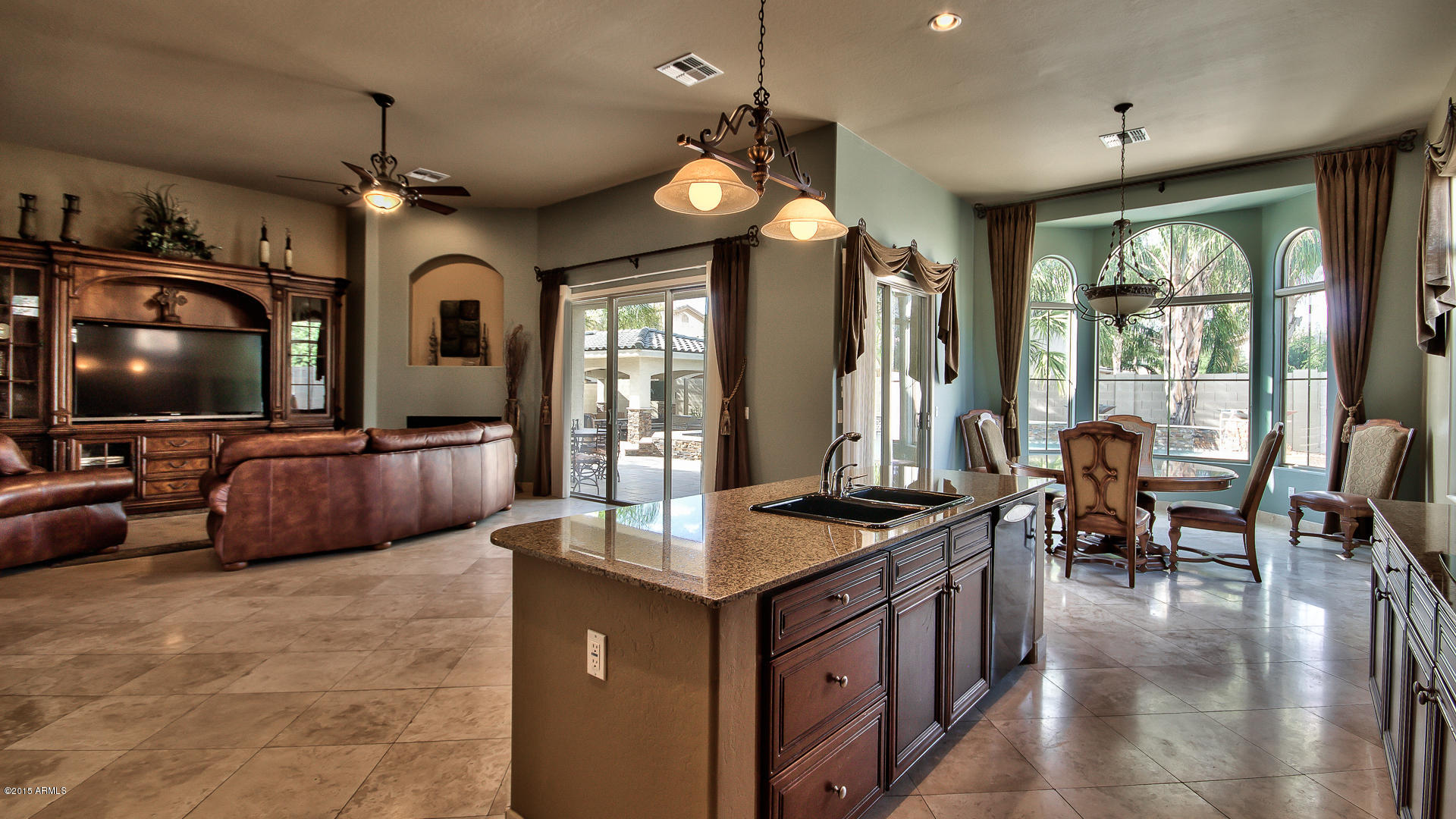 4782 East Buckboard Road Gilbert, AZ 85297 - Photo 11 of 57 a living room with furniture a flat screen tv and floor to ceiling window