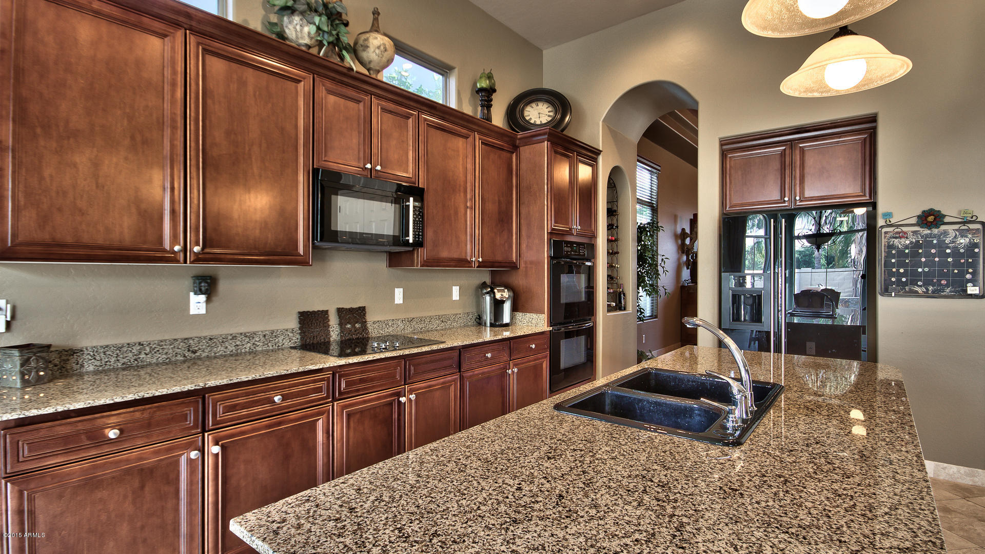 4782 East Buckboard Road Gilbert, AZ 85297 - Photo 14 of 57 a kitchen with stainless steel appliances granite countertop a sink a stove and cabinets