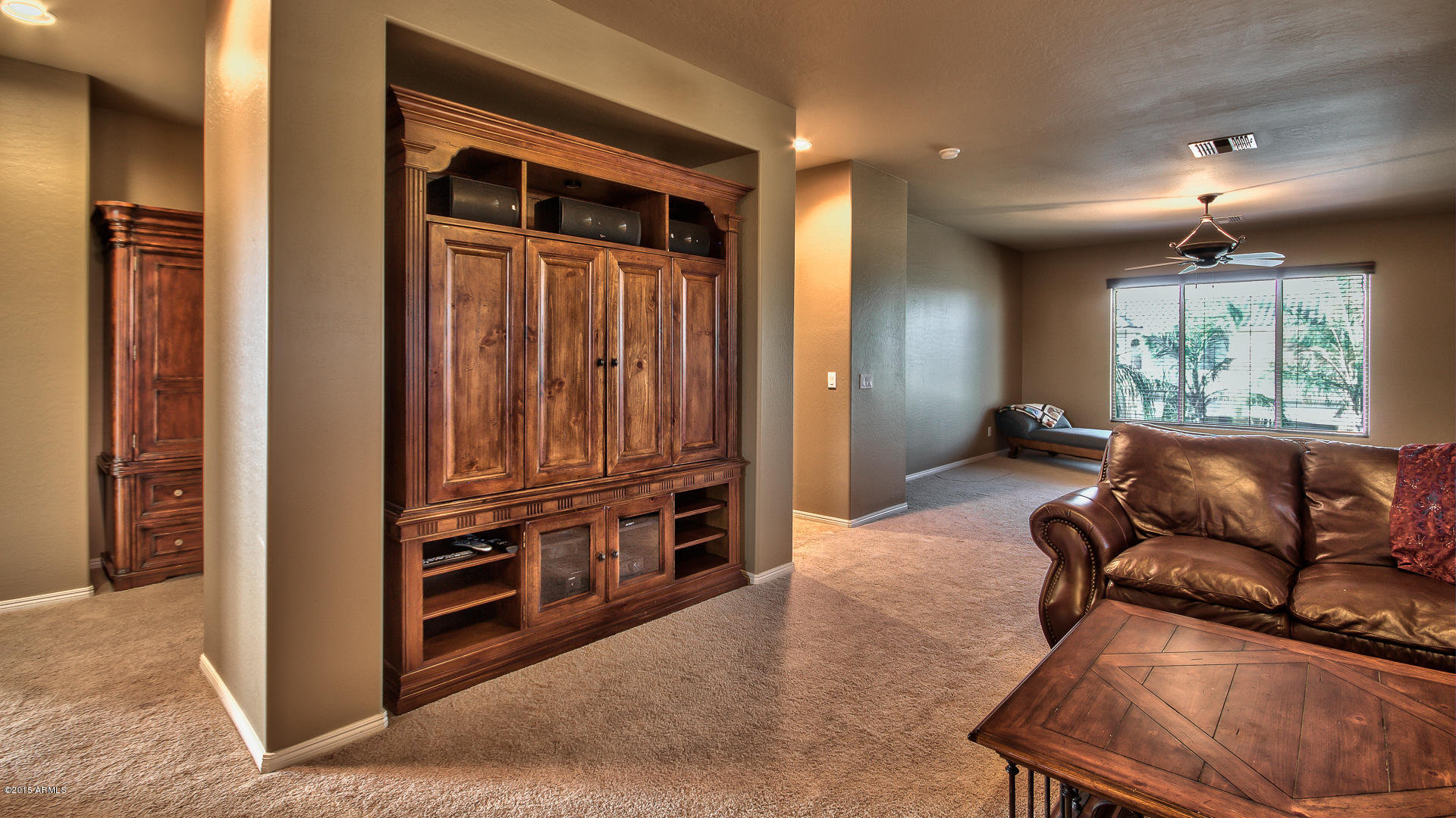 4782 East Buckboard Road Gilbert, AZ 85297 - Photo 25 of 57 a living room with furniture a flat screen tv and a window