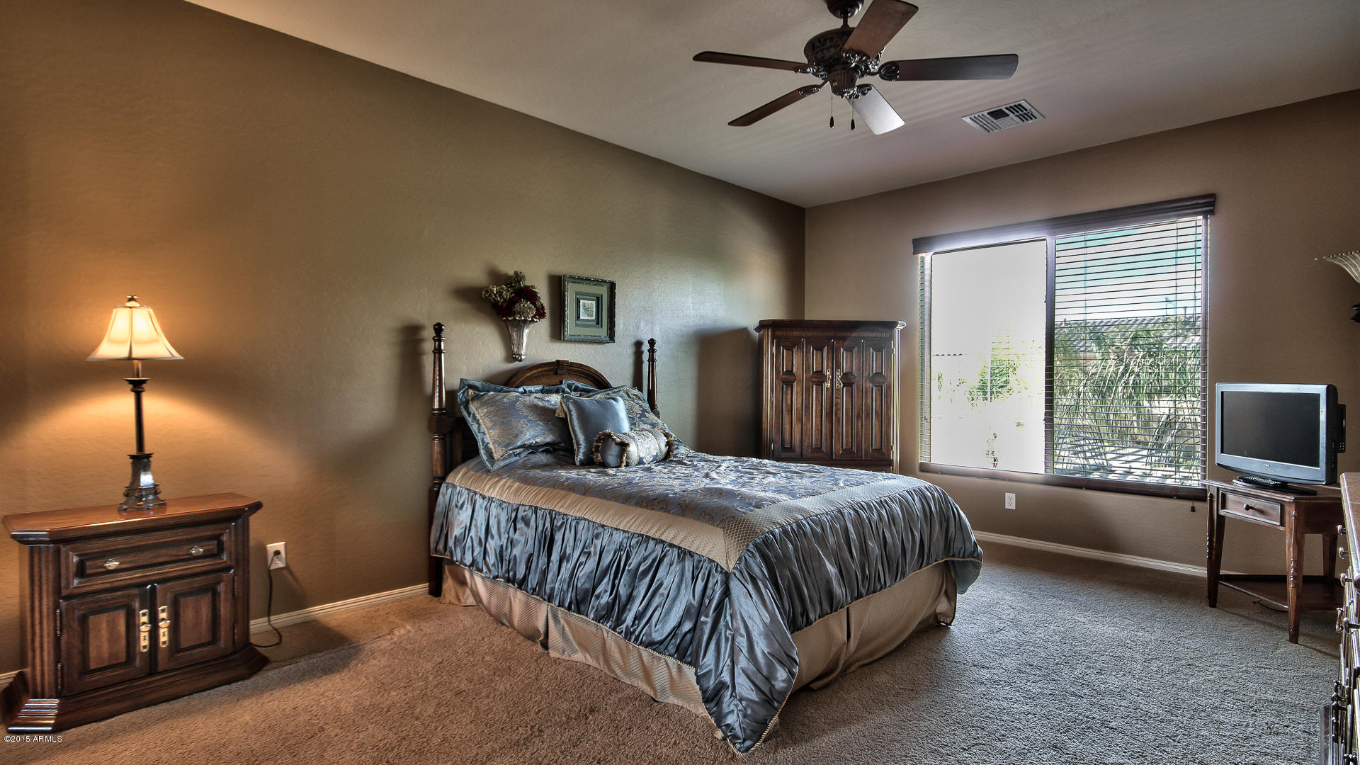 4782 East Buckboard Road Gilbert, AZ 85297 - Photo 29 of 57 a bedroom with a bed and a chandelier