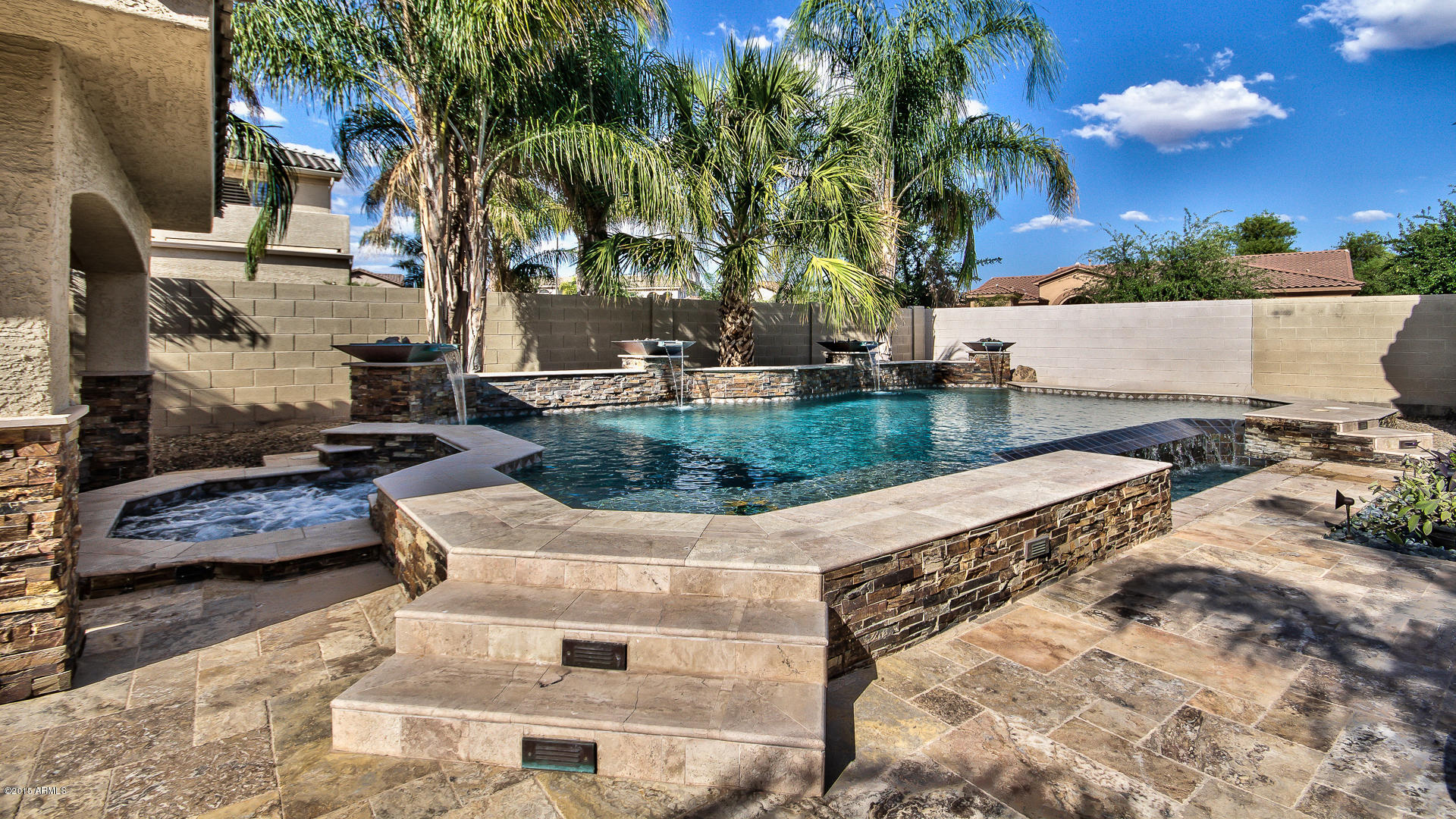 4782 East Buckboard Road Gilbert, AZ 85297 - Photo 36 of 57 a view of a backyard with lawn chairs and palm trees
