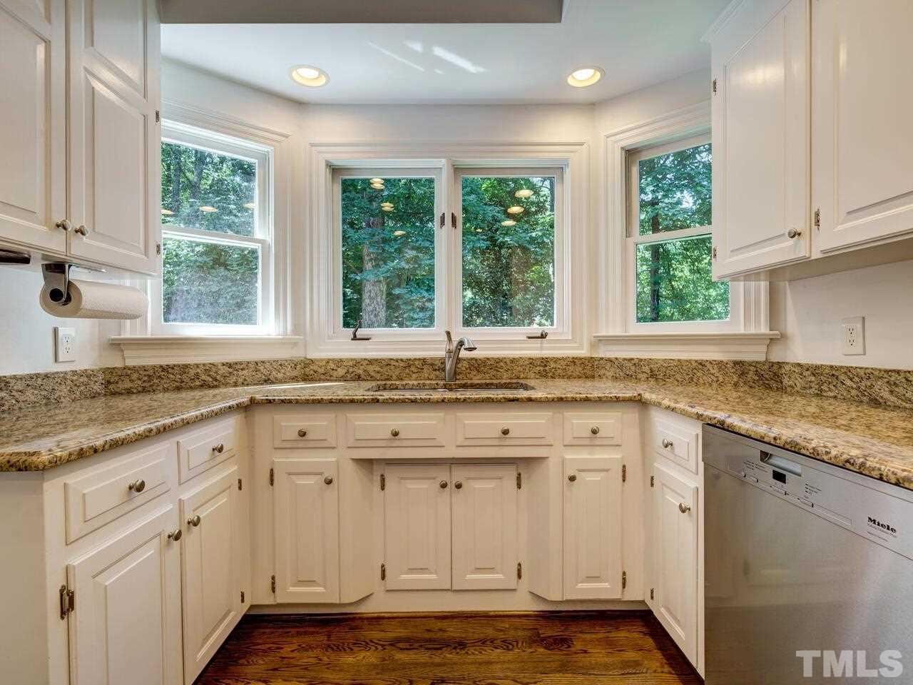 Three windows into the backyard and deck from the Kitchen.