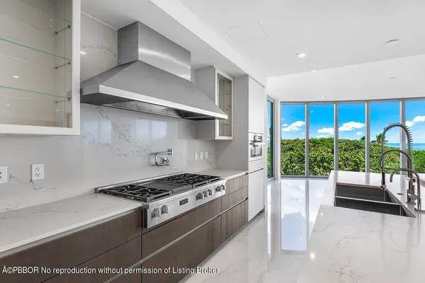 a kitchen with granite countertop a stove and a sink